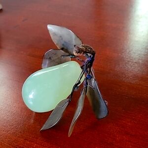 Jadeite grape on stand with leaves.